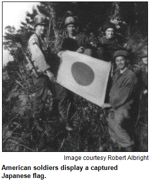 American soldiers display a captured Japanese flag. Image courtesy Robert Albright.