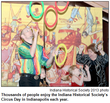 Man juggling hoops while girl and woman exclaim, at the 2013 Circus Day at the Indiana Historical Society. Photo courtesy Indiana Historical Society.