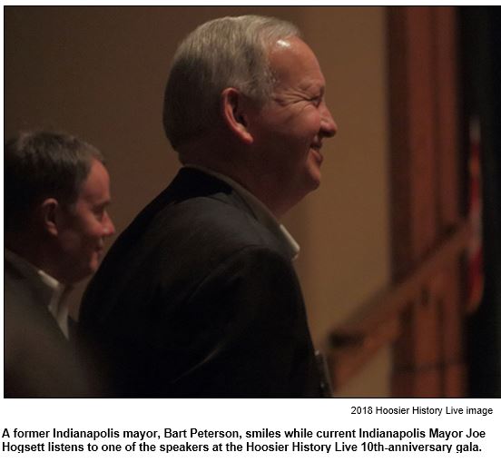A former Indianapolis mayor, Bart Peterson, smiles while current Indianapolis Mayor Joe Hogsett listens to one of the speakers at the Hoosier History Live 10th-anniversary gala.