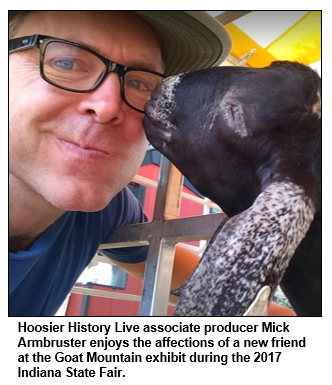 Hoosier History Live associate producer Mick Armbruster enjoys the affections of a new friend at the Goat Mountain exhibit during the 2017 Indiana State Fair. 
