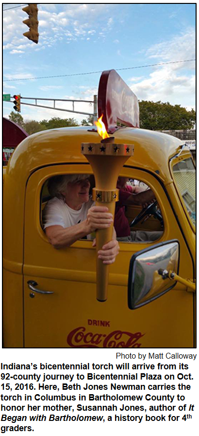 Indiana’s bicentennial torch will arrive from its 92-county journey to Bicentennial Plaza on Oct. 15, 2016. Here, Beth Jones Newman carries the torch in Columbus in Bartholomew County to honor her mother, Susannah Jones, author of It Began with Bartholomew, a history book for 4th graders. Photo by Matt Calloway.